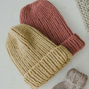 Two knit beanies in mustard and pumpkin color